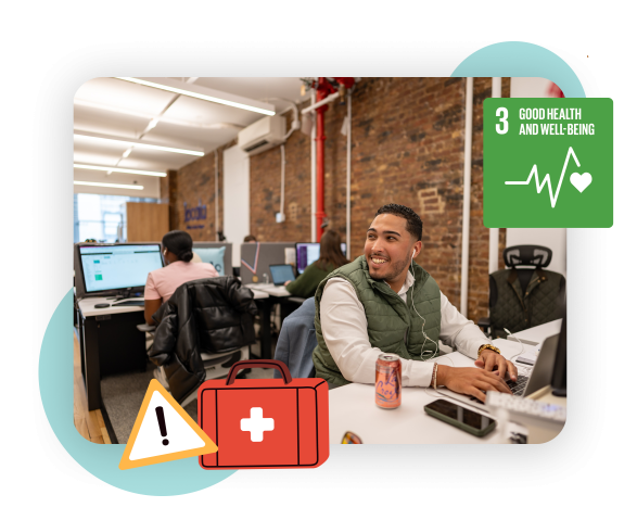 Photo of an employee working at his desk and smiling. We can see some ergonomics desk chairs. There are also health icons